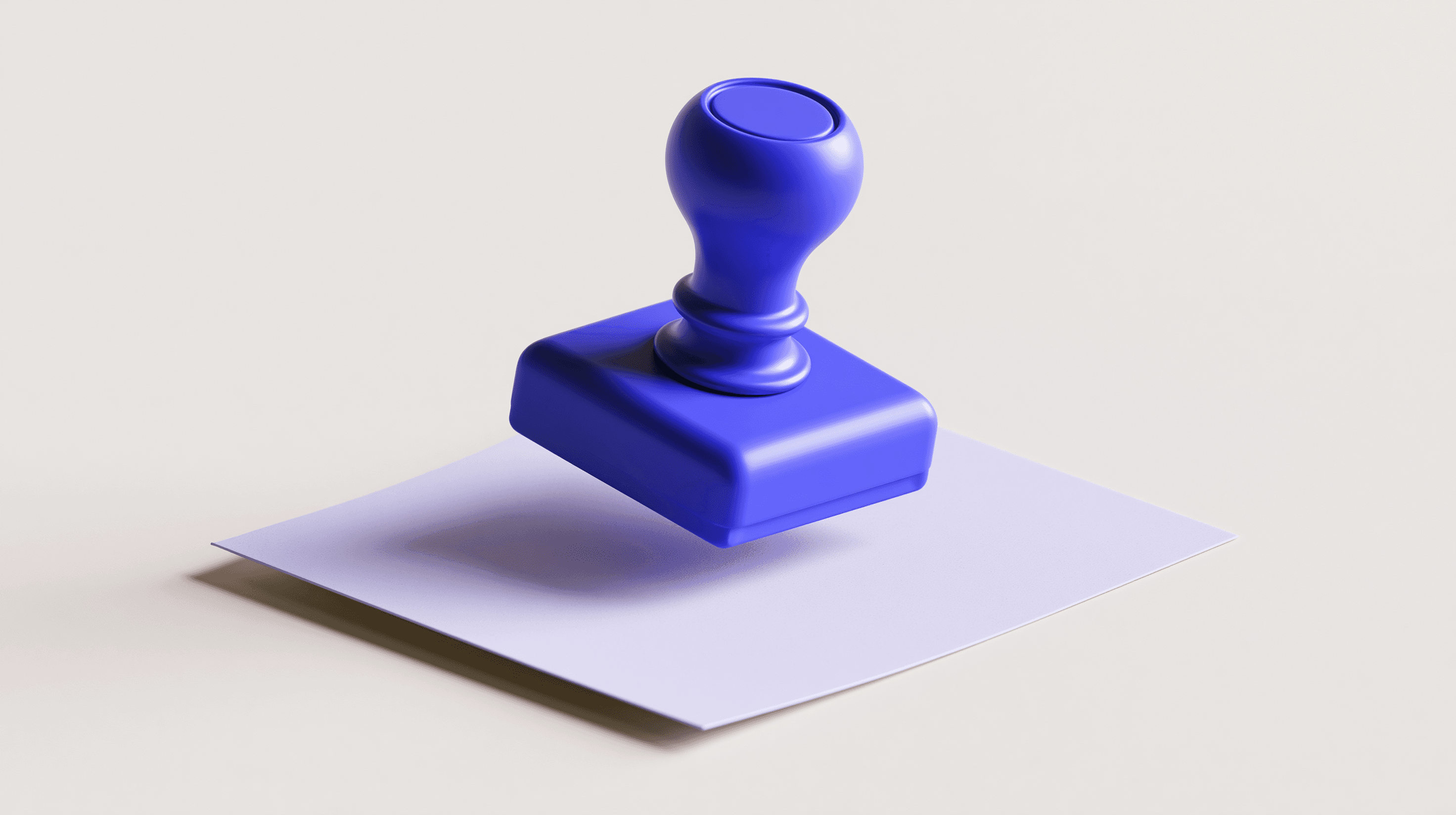 A blue rubber stamp resting on a blank sheet of paper